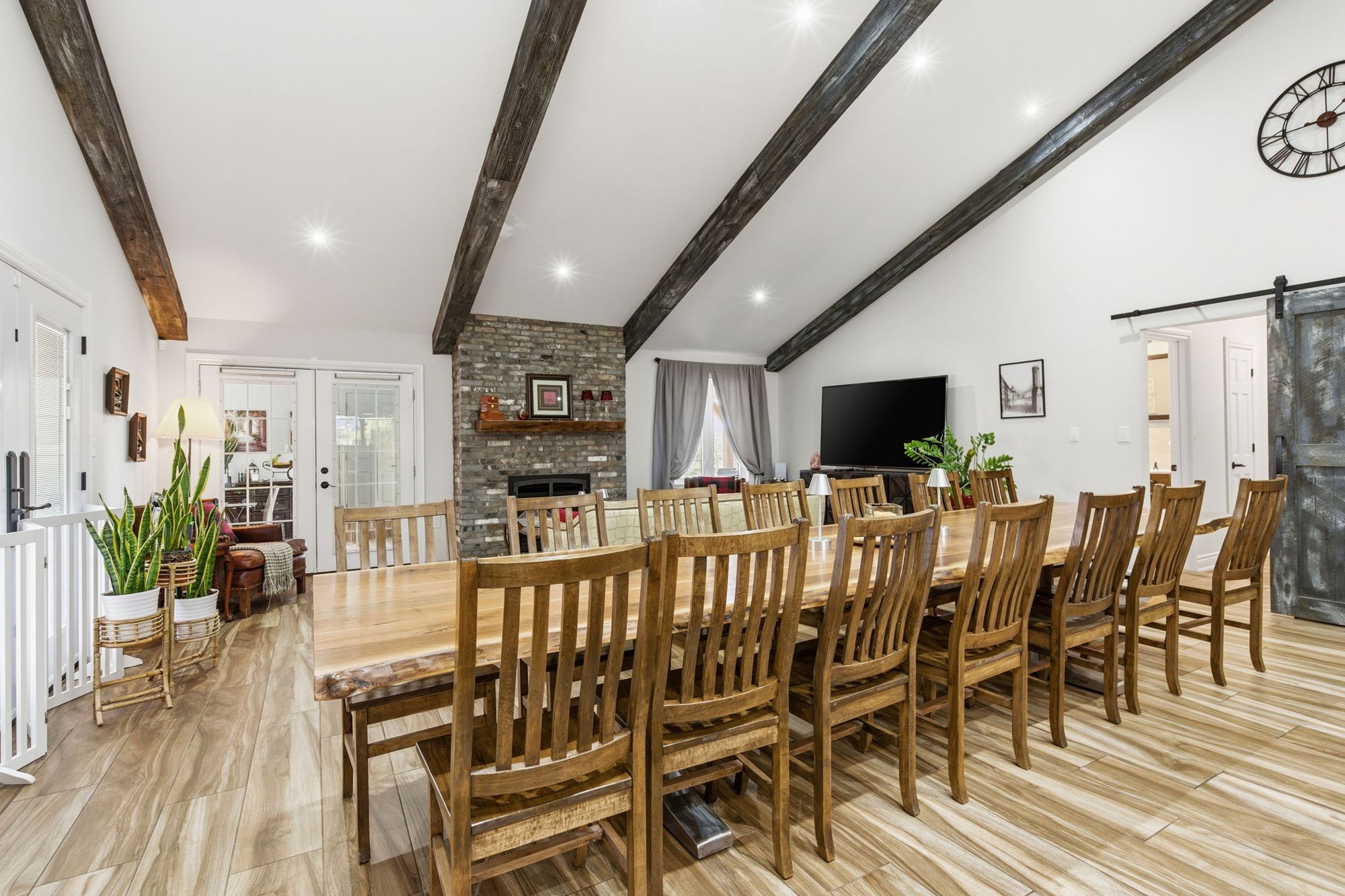 A long dining table under the beamed, vaulted ceiling