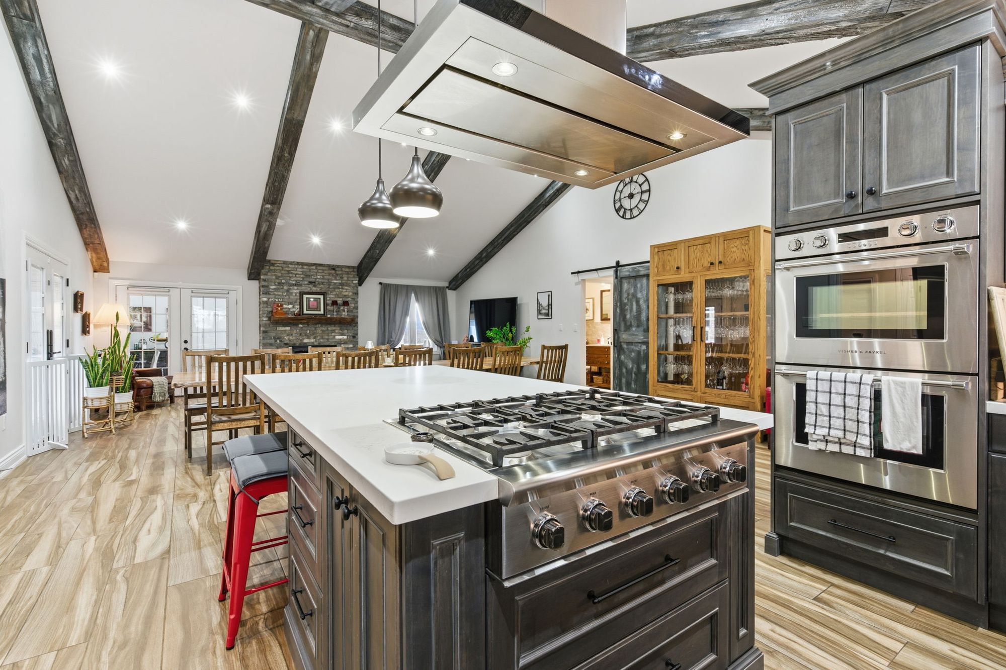 The kitchen with its island, gas range and double wall ovens