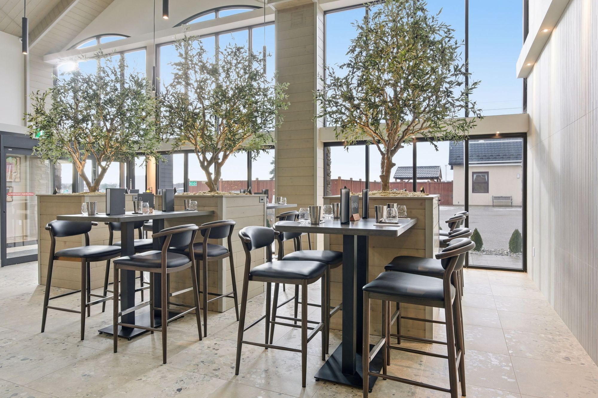 High-top tables among the olive trees