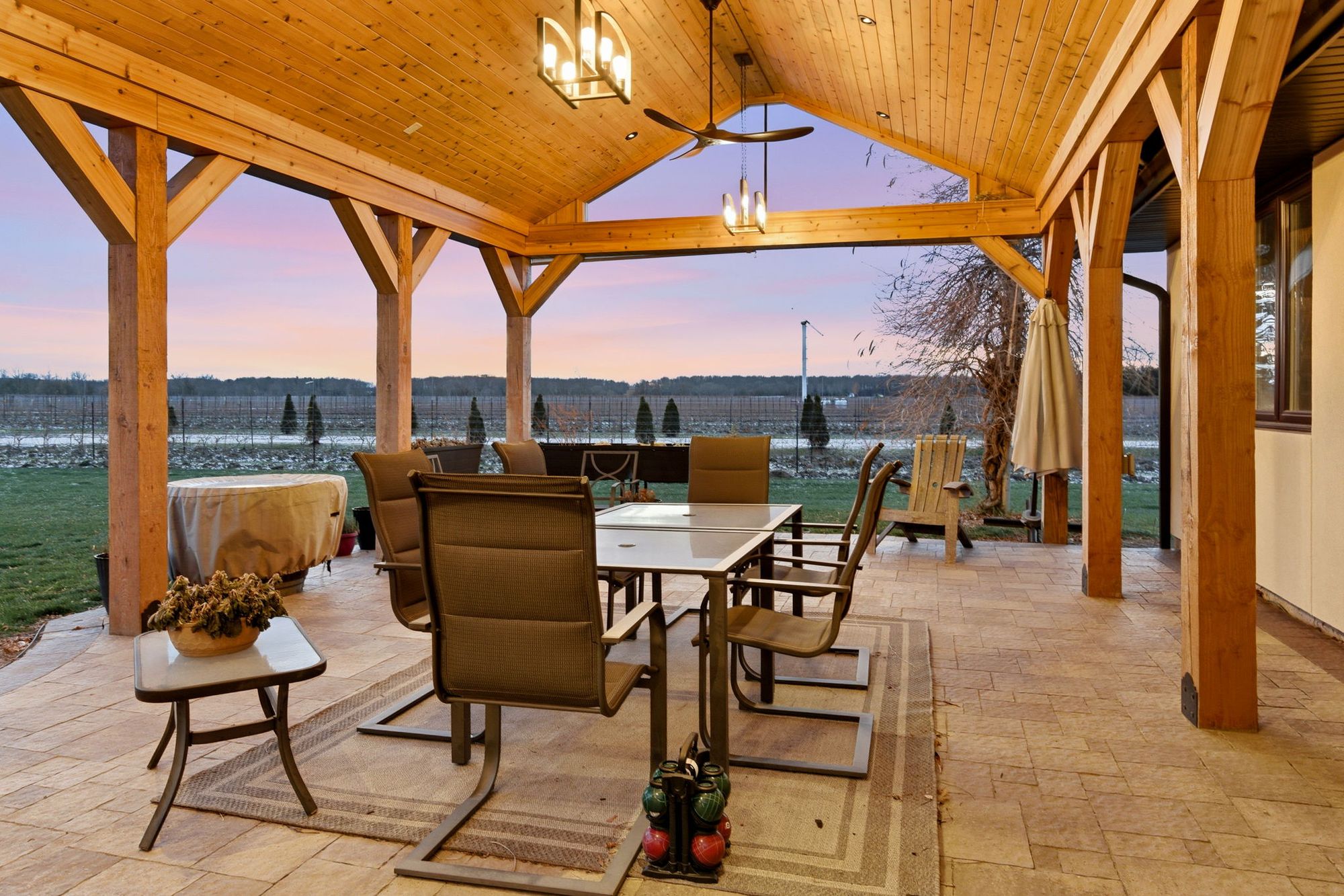 Dining under the pavilion's cedar ceiling at dusk