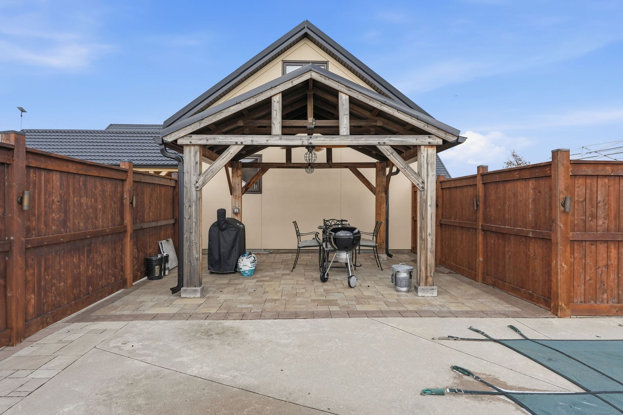 The pool's covered cabana behind a private fence