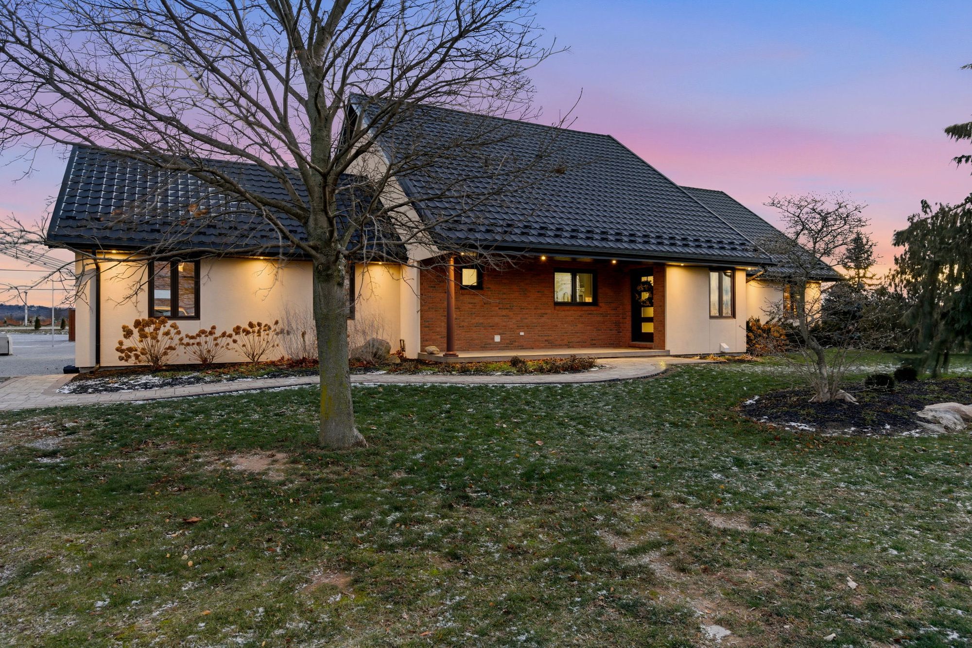 The residence lit at dusk