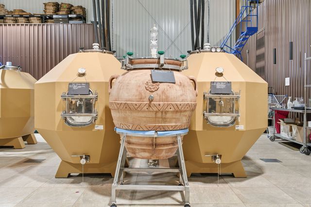 A clay amphora between concrete tanks