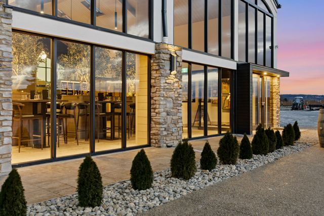 The tasting room glowing through its glass at dusk